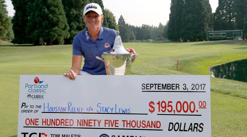 Stacy Lewis shows off the winner's check on the 18th green after her victory during the final round of the LPGA Cambia Portland Classic. Lewis donated all of her winnings to the Hurricane Harvey Houston Relief effort.