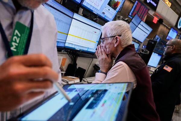 Trader Peter Herits, center, works on the options floor of the New York Stock Exchange, Thursday, April 10, 2025. (AP Photo/Richard Drew)