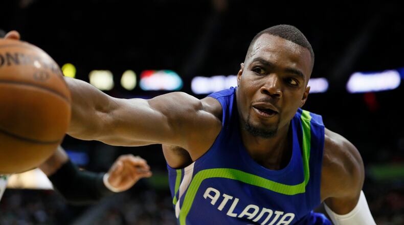Atlanta Hawks forward Paul Millsap fights to save the ball in the second half of an NBA basketball game against the Boston Celtics on Thursday, April 6, 2017, in Atlanta. The Hawks won the game 123-116. (AP Photo/Todd Kirkland)