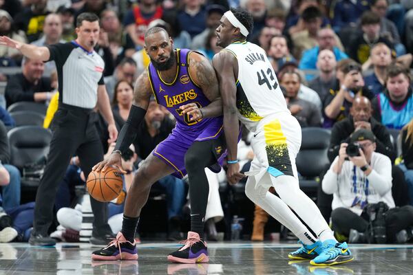 Los Angeles Lakers forward LeBron James (23) moves into Indiana Pacers forward Pascal Siakam (43) during the second half of an NBA basketball game in Indianapolis, Wednesday, March 26, 2025. (AP Photo/AJ Mast)
