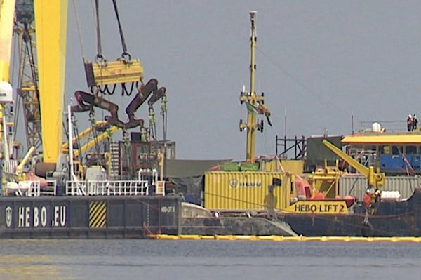 The hull of the superyacht Bayesian, which sank near Palermo, Sicily, on August 19, 2024, is lifted by cranes during salvage operations off the village of Porticciolo on Friday, June 20, 2025. (Rosalia Bonfardino)
