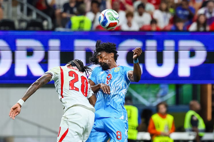 Congo midfielder Samuel Moutoussamy (right) and England forward Noni Madueke (left) head the ball during the first half of a FIFA World Cup round of 32 match at Atlanta Stadium (Mercedes-Benz Stadium) on Wednesday, July 1, 2026, in Atlanta. (Jason Getz/AJC)