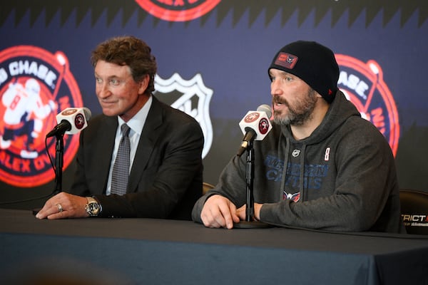 Former NHL player Wayne Gretzky, left, with Washington Capitals Alex Ovechkin, right, during a press conference after an NHL hockey game in which Ovechkin tied Gretzky's NHL career goals record of 894th goals, Friday, April 4, 2025, in Washington. (AP Photo/Nick Wass)
