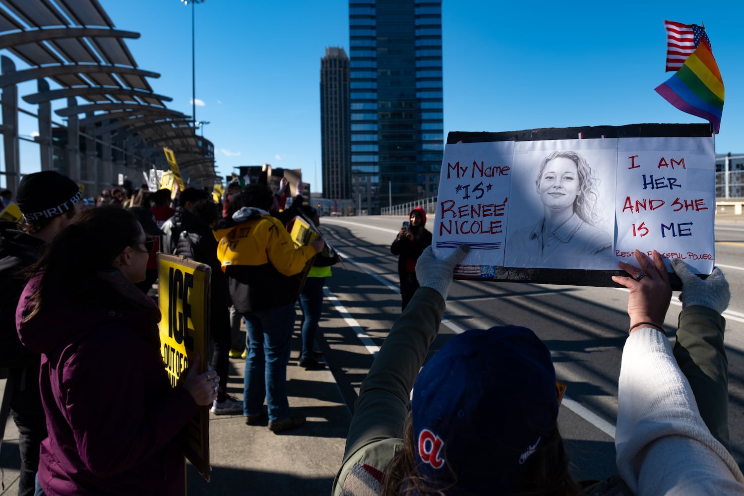 A woman who shares the name Reneé Nicolejoins others on the 17th Street Bridge in Atlanta on Sunday, Jan. 11, 2026 to protest the ICE shooting of Renee Good and the US military action in Venezuela. Ben Gray for the Atlanta Journal-Constitution