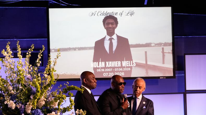 Elmore Wonsley, center, speaks next to attorney Ben Crump, left, and Rev. Al Sharpton during a memorial service for Nolan Xavier Wells, an 18-year-old found dead after taking a July 4 boat trip with friends, Monday, July 20, 2026, in Ocean Springs, Miss. (AP Photo/Gerald Herbert)