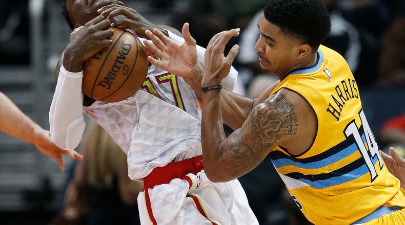 Atlanta Hawks guard Dennis Schroder (17) and Denver Nuggets guard Gary Harris (14) battle for the ball during the second half of an NBA basketball game Wednesday, Feb. 8, 2017 in Atlanta. Atlanta won, 117-106. (AP Photo/John Bazemore)
