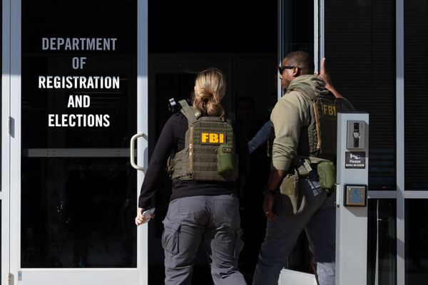 FBI agents enter the Fulton County Election Hub and Operation Center in Union City on Wednesday, Jan. 28, 2026, as the FBI conducts a raid. (Arvin Temkar/AJC)