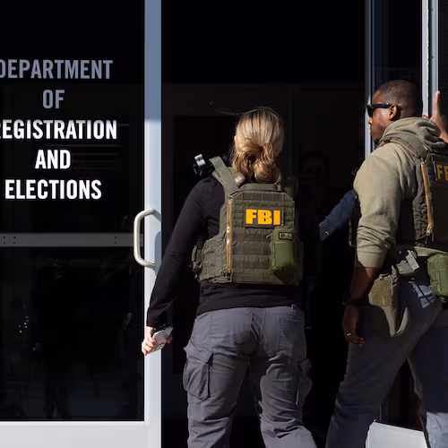 FBI agents enter the Fulton County Election Hub and Operation Center in Union City on Wednesday, Jan. 28, 2026, as the FBI conducts a raid. (Arvin Temkar/AJC)