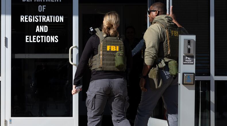 FBI agents enter the Fulton County Election Hub and Operation Center in Union City on Wednesday, Jan. 28, 2026, as the FBI conducts a raid. (Arvin Temkar/AJC)