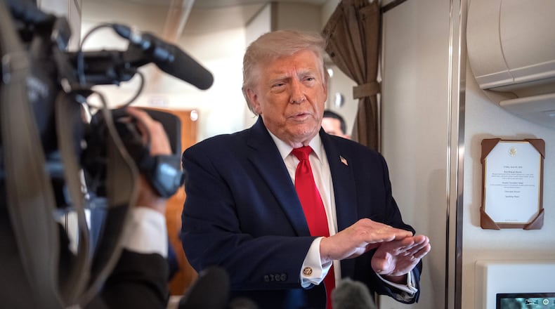 President Donald Trump speaks to reporters aboard Air Force One en route from Joint Base Andrews, Md., to Eau Claire, Wis., Friday, June 5, 2026. (AP Photo/Mark Schiefelbein)