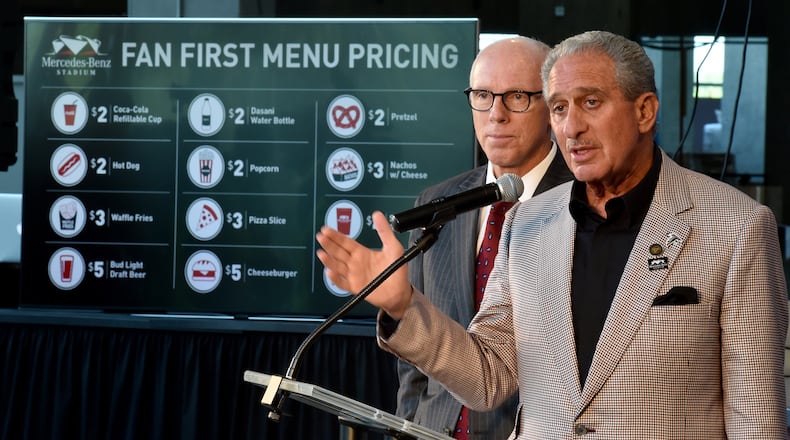 Falcons owner Arthur Blank, right, with team president Rich McKay, announced "fan first" menu pricing in 2016 but the cost to get into a Falcons' game in 2017 is hardly "fan first." (Brant Sanderlin / Atlanta Journal-Constitution)