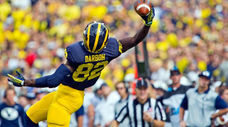 Michigan wide receiver Amara Darboh (82) makes a one-handed catch in the first quarter of an NCAA college football game against BYU in Ann Arbor, Mich., Saturday, Sept. 26, 2015. (AP Photo/Tony Ding)