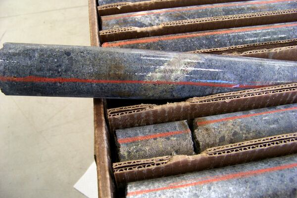 FILE - A core sample drilled from underground rock near Ely, Minn., shows a band of shiny minerals containing copper, nickel and precious metals, center, that Twin Metals Minnesota LLC, hopes to mine near the Boundary Waters Canoe Area Wilderness in northeastern Minnesota, Oct. 4, 2011. (AP Photo/Steve Karnowski, File)
