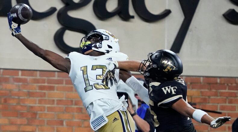 Georgia Tech wide receiver Eric Singleton Jr. (13) reaches in vain for a pass as Wake Forest defensive back Nick Andersen (45) defends during the first half of an NCAA college football game in Winston-Salem, N.C., Saturday, Sept. 23, 2023. (AP Photo/Chuck Burton)