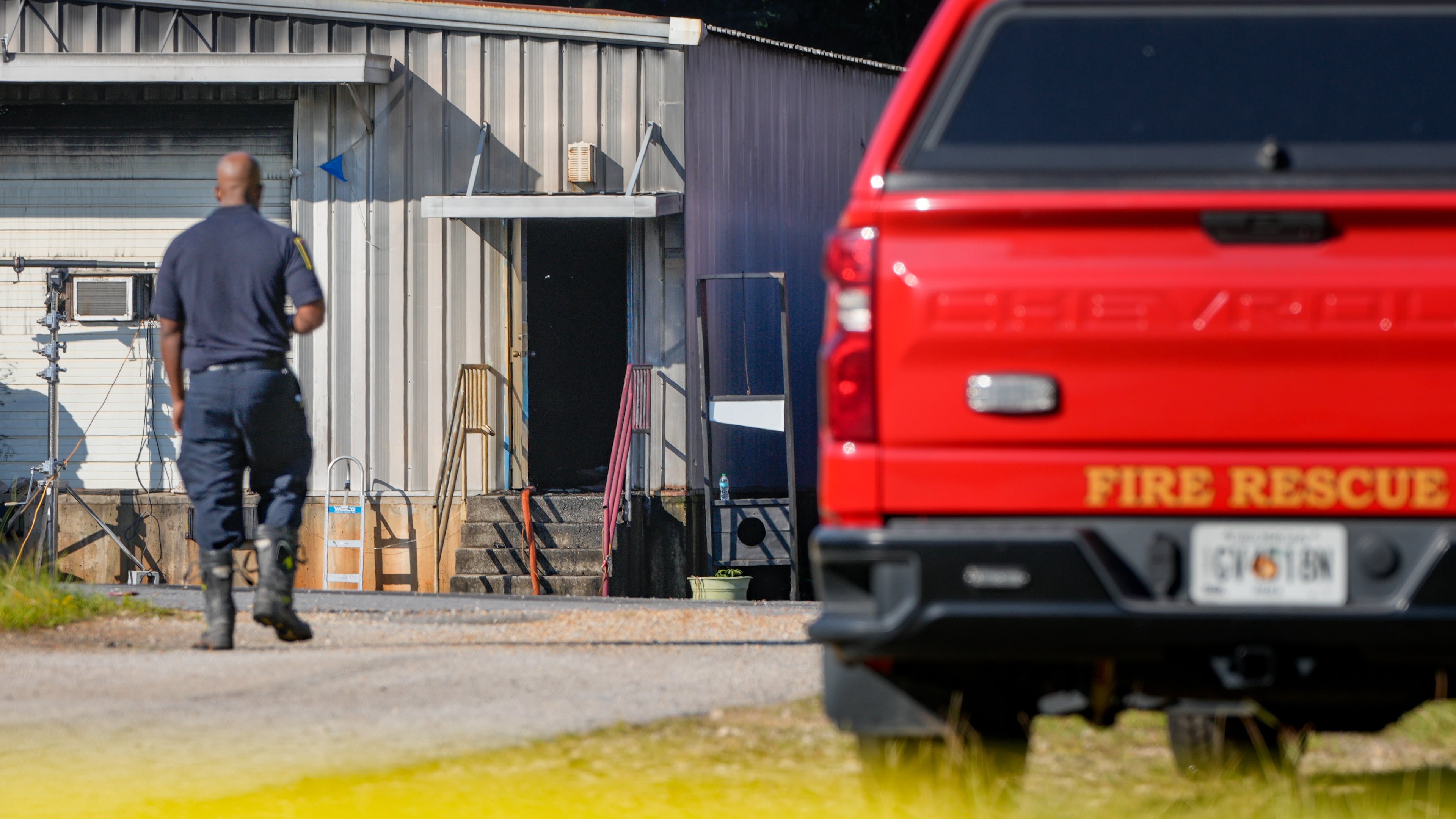 DeKalb County fire officials and state fire investigators inspect the site where a DeKalb firefighter was fatally injured Monday. (Ben Hendren for The Atlanta Journal-Constitution)