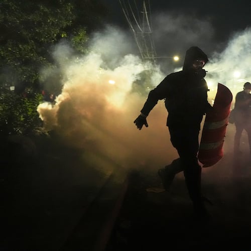Anti-ICE protesters disperse during clashes with law enforcement officers outside the Delaney Hall detention center on Saturday, May 30, 2026, in Newark, N.J. (AP Photo/Angelina Katsanis)