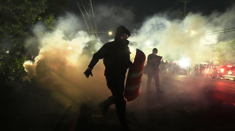 Anti-ICE protesters disperse during clashes with law enforcement officers outside the Delaney Hall detention center on Saturday, May 30, 2026, in Newark, N.J. (AP Photo/Angelina Katsanis)