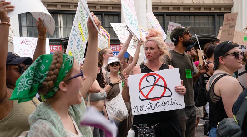 People march in the street during a protest against the Supreme Court's ruling in the Dobbs v Jackson Women's Health Organization on June 25, 2022, in Atlanta, Georgia. The Court's decision in the Dobbs v Jackson Women's Health case overturns the landmark 50-year-old Roe v Wade case, removing a federal right to an abortion. (Elijah Nouvelage/Getty Images/TNS)
