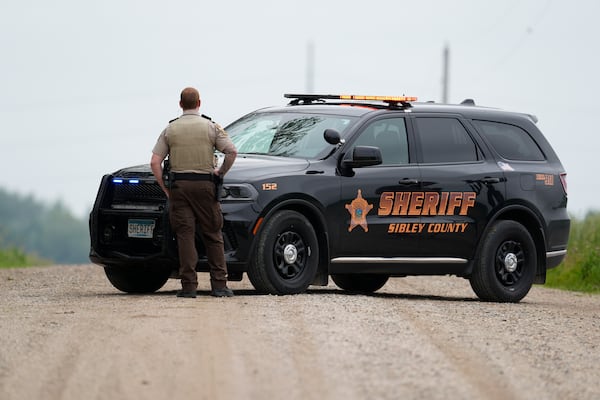 A Sibley County Sheriff's Deputy blocks the road where the suspect involved in the shooting of two state lawmakers vehicle was found Sunday, June 15, 2025, in Faxon Township, Minn. (AP Photo/George Walker IV)