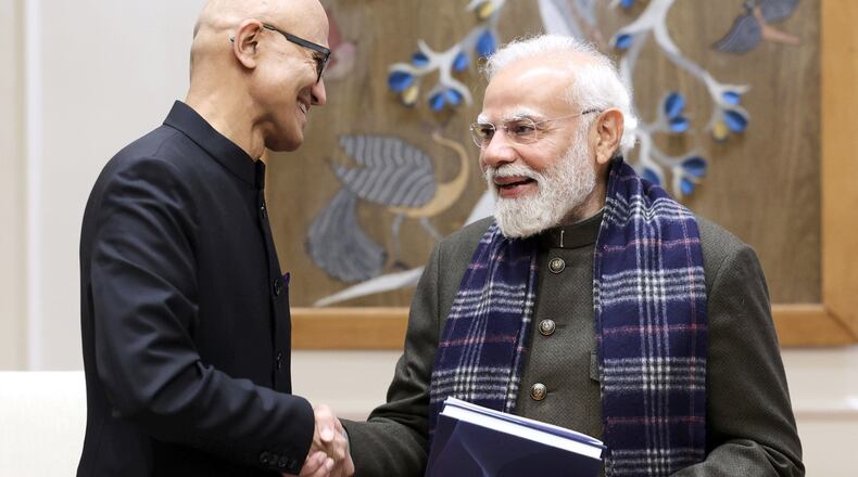 In this handout photo provided by Microsoft, Chief Executive Officer Satya Nadella, left, shakes hands with Indian Prime Minister Narendra Modi during their meeting in New Delhi, India, Tuesday, Dec. 9, 2025. (Microsoft via AP)