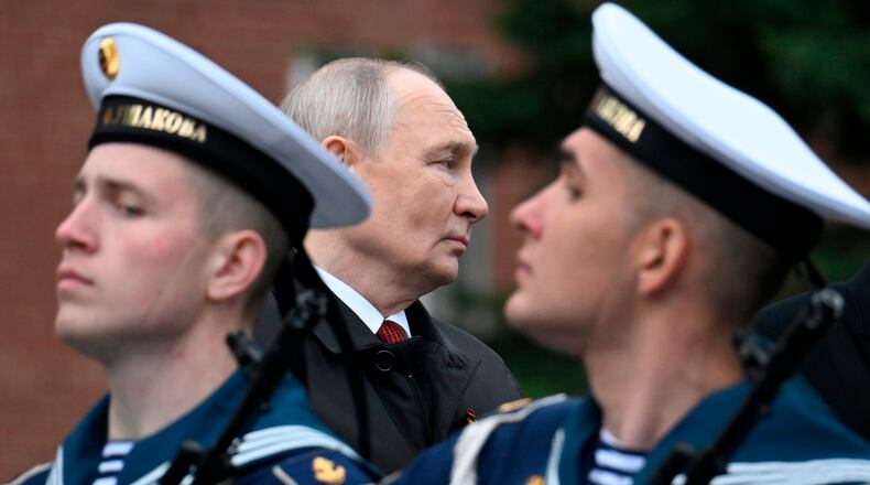 Russian President Vladimir Putin, centre foreground, attends a ceremony to lay flowers at the Tomb of the Unknown Soldier by the Kremlin wall inMoscow, Saturday, May 9, 2026, during celebrations of the 81st anniversary of the Soviet Union's victory over Nazi Germany during the World War II. (Alexander Nemenov/Pool Photo via AP)