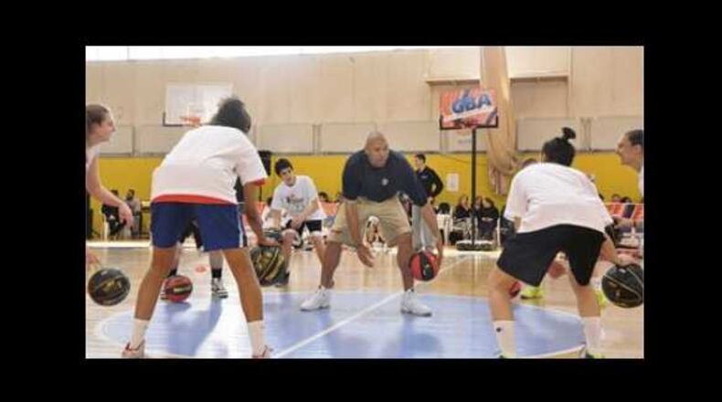 Tracy Murray, former NBA player who now works as an assistant coach with the Los Angeles Lakers, teaches children as part of the U.S. State Department's international sports diplomacy program.