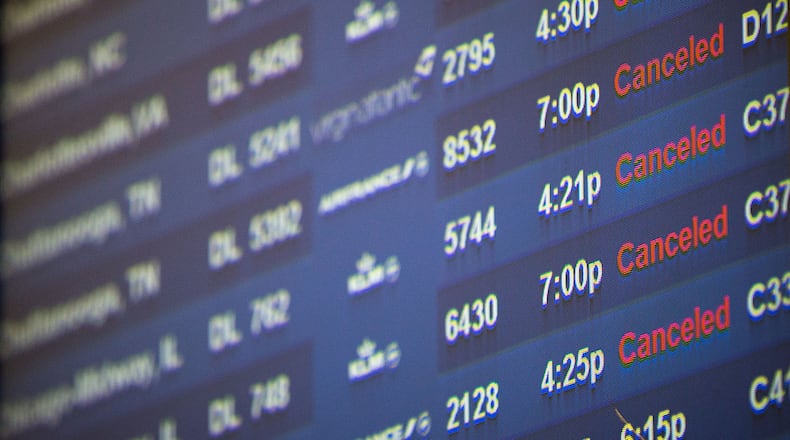In this file photo, monitors show several canceled Delta flights at Hartsfield-Jackson Atlanta International Airport, Friday, Jan. 6, 2017, in Atlanta. Delta canceled about 350 flights due to inclement weather.  BRANDEN CAMP/SPECIAL
