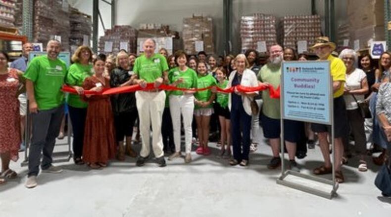 Board members, staff, volunteers and partners of Backpack Buddies cut the ribbon at the organization's new storage and distribution facility. (Courtesy of Backpack Buddies of Metro Atlanta)