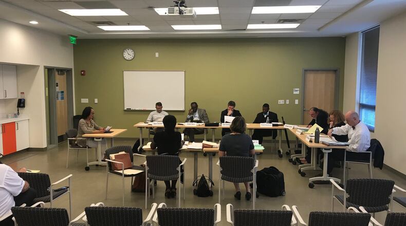 Kelly Cato (far left), who worked as an aide to former DeKalb Commissioner Stan Watson, testifies before the Board of Ethics during a hearing where Watson was later fined $9,000 for ethics violations. TIA MITCHELL/TIA.MITCHELL@AJC.COM