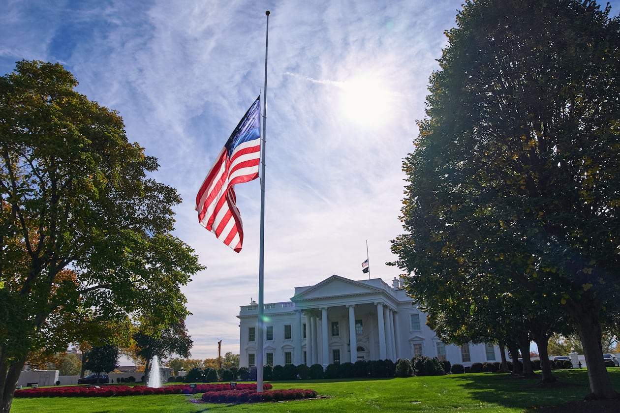 The American flag is seen at half-staff, Tuesday, Nov. 4, 2025, at the White House in Washington. (AP Photo/Jacquelyn Martin)
