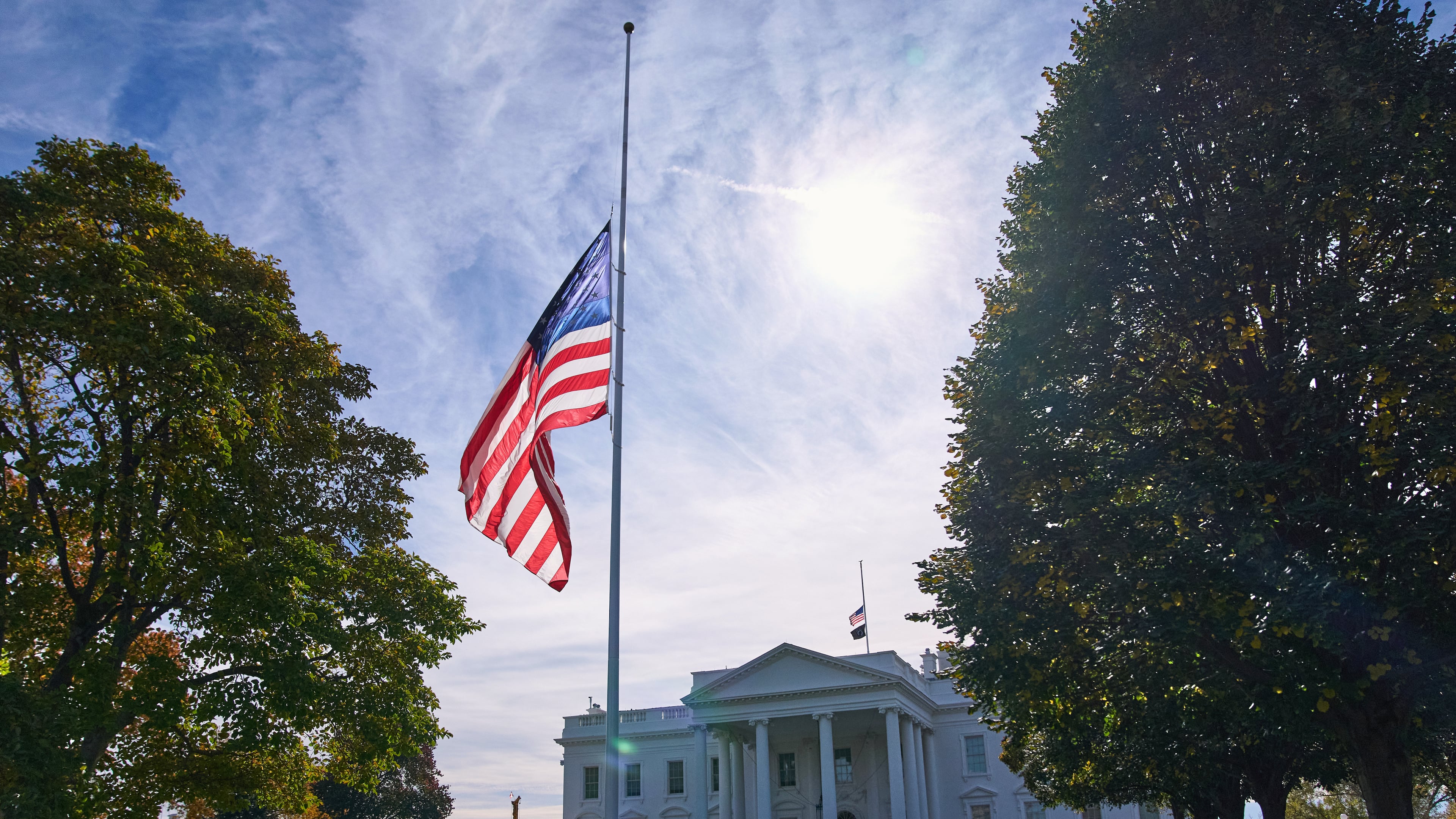 The American flag is seen at half-staff, Tuesday, Nov. 4, 2025, at the White House in Washington. (AP Photo/Jacquelyn Martin)