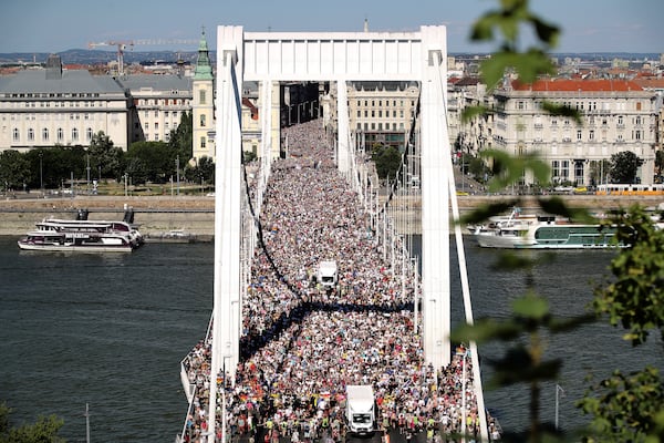 Participants in the Pride march cross the Elisabeth Bridge in Budapest, Hungary, Saturday, June 28, 2025. (AP Photo/Rudolf Karancsi)