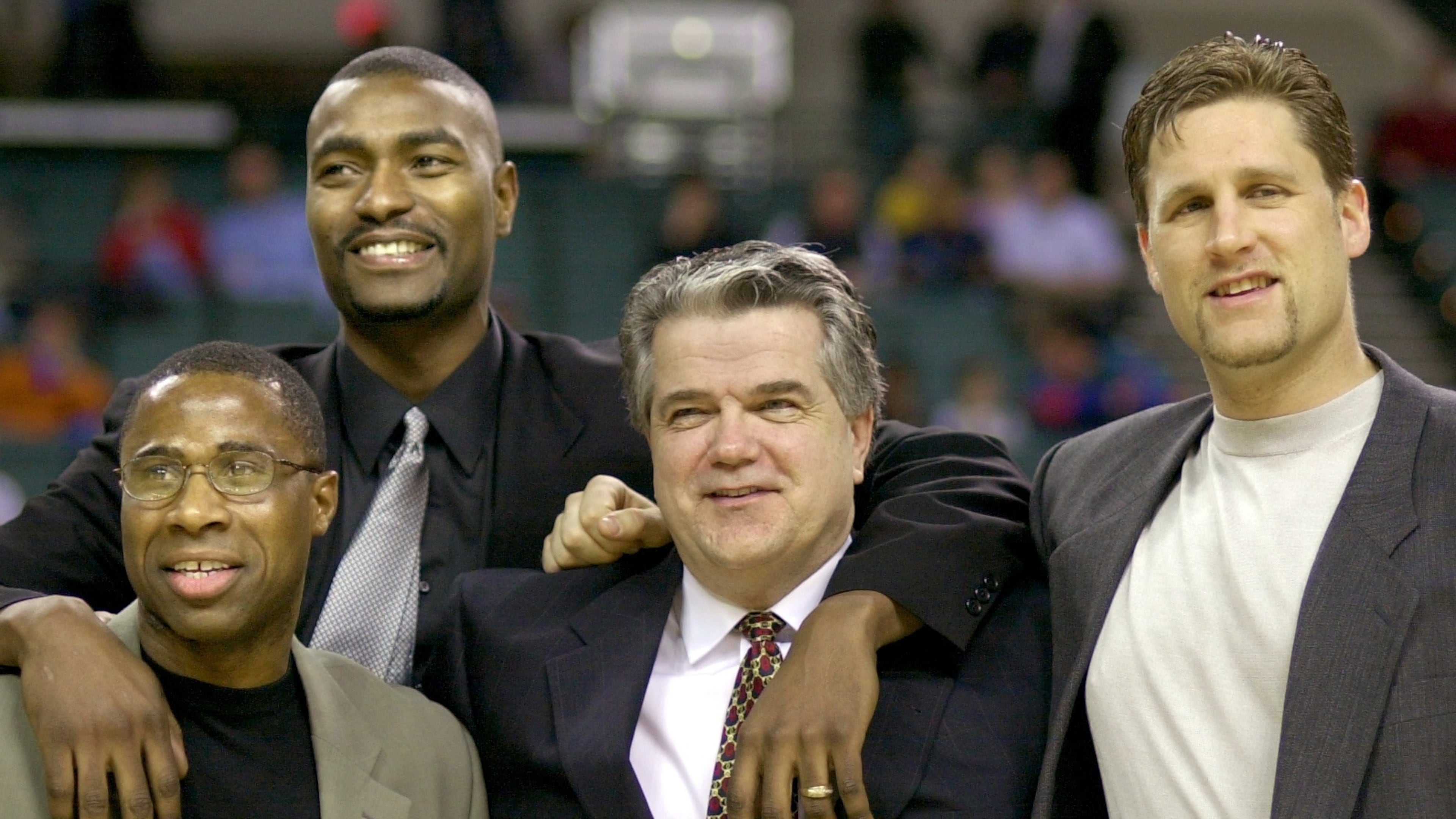 FILE - Members of the 1986 Cleveland State University men's basketball team, from left, Shawn Hood, Eric Mudd, coach Kevin Mackey, and Pat Vuyanich are honored during halftime of an NCAA college basketball game, Jan. 20, 2001, in Cleveland. (Larry Hamel-Lambert/The Plain Dealer via AP, File)