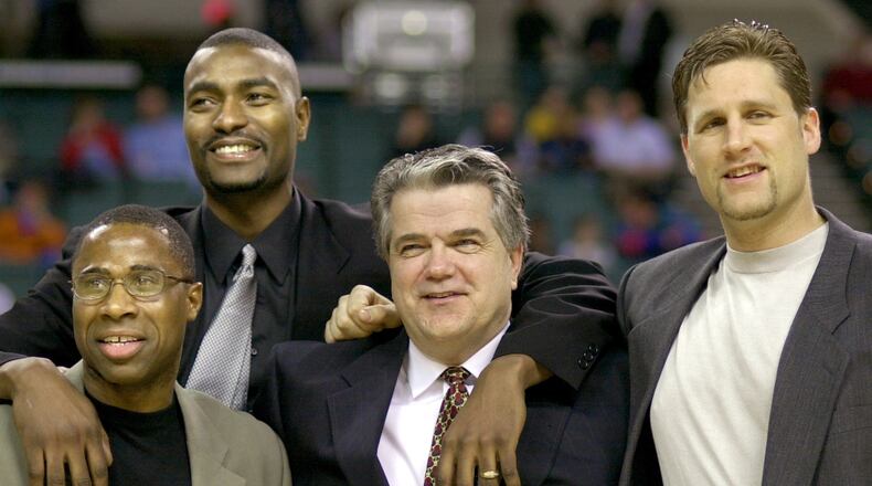 FILE - Members of the 1986 Cleveland State University men's basketball team, from left, Shawn Hood, Eric Mudd, coach Kevin Mackey, and Pat Vuyanich are honored during halftime of an NCAA college basketball game, Jan. 20, 2001, in Cleveland. (Larry Hamel-Lambert/The Plain Dealer via AP, File)