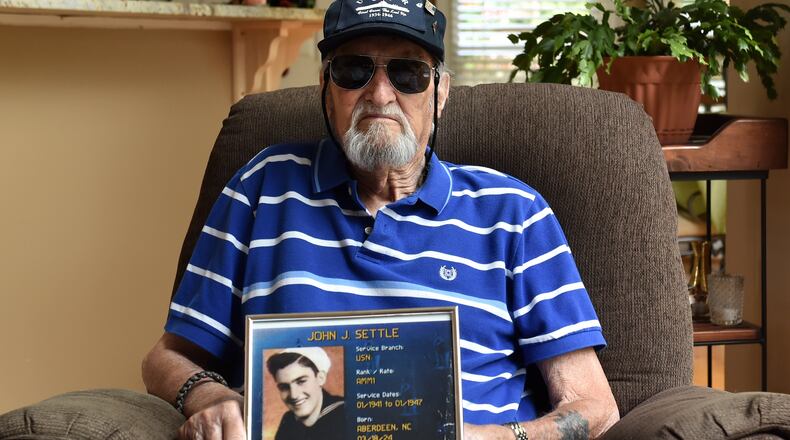 Jeff Settle served in the Navy during WW II. Settle received the Purple Heart after when he was injured during a bombing. Shown August 20, 2015 at his Marietta home.