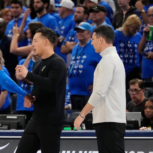 San Antonio Spurs head coach Mitch Johnson, center, talks with Oklahoma City Thunder guard Shai Gilgeous-Alexander (2) as Thunder head coach Mark Daigneault looks on during the second half of Game 7 of the Western Conference finals of the NBA basketball playoffs series Saturday, May 30, 2026, in Oklahoma City. (AP Photo/Tony Gutierrez)