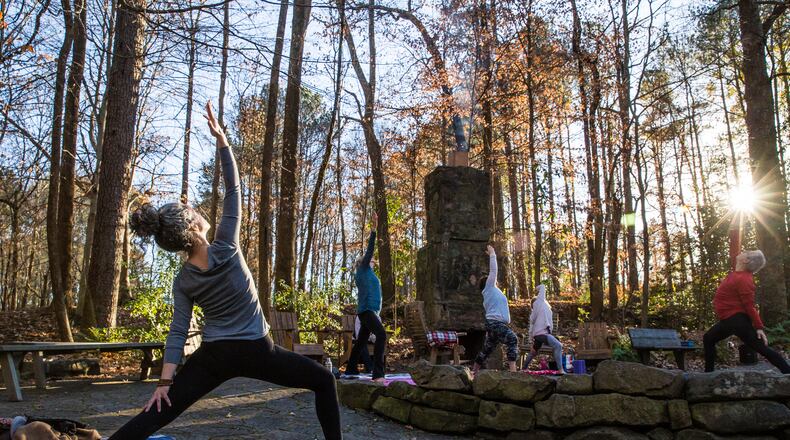 Marking the official beginning of winter, Dunwoody Nature Center holds an outdoor yoga class on the solstice where Kim Hobbes, left, participates in the hour-long class Monday, Dec 21, 2020. (Jenni Girtman for The Atlanta Journal-Constitution)
