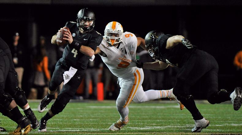 NASHVILLE, TN - NOVEMBER 29: Quarterback Patton Robinette #4 of the Vanderbilt Commoroders is pressured by Derek Barnett #9 of the Tennessee Volunteers during the second half of a game at Vanderbilt Stadium on November 29, 2014 in Nashville, Tennessee. (Photo by Frederick Breedon/Getty Images)