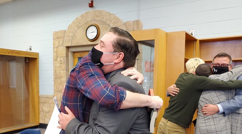 Spencer Jordan, a Campbell High School drama teacher, hugs a former student after a panel overturned the Cobb school district's decision not to renew his contract. Credit: Kristal Dixon/The Atlanta Journal-Constitution.