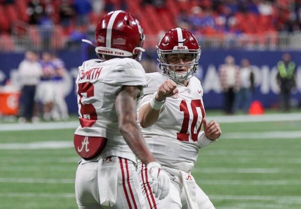Alabama Crimson Tide wide receiver DeVonta Smith (6) gets a fist bump from quarterback Mac Jones (10) after his first quarter TD catch during SEC Championship against Florida Saturday, Dec. 19, 2020, at Mercedes-Benz Stadium in Atlanta. (Curtis Compton / Curtis.Compton@ajc.com)  