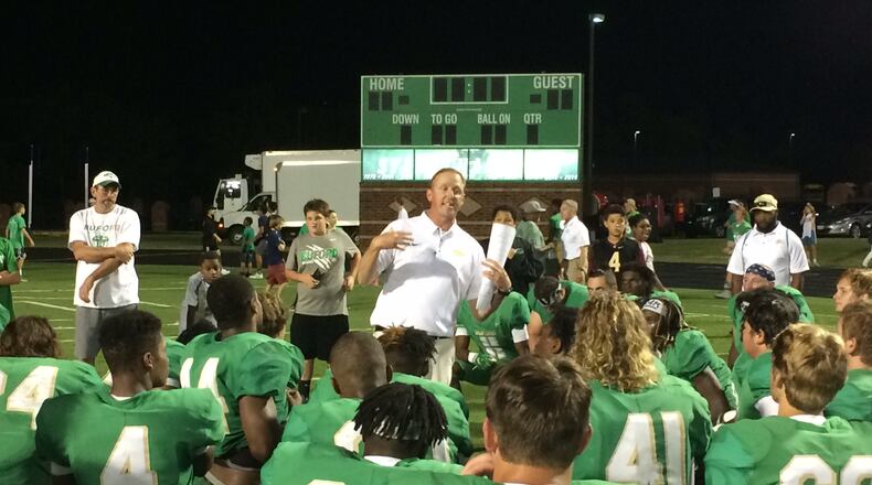 Coach John Ford addresses the Buford players after their win over Clarke Central.