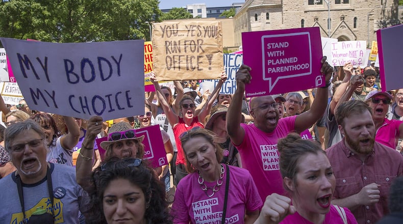 Abortion rights supporters hold protest signs and chant as they gather outside the Georgia Capitol last month during a rally in Atlanta. The ACLU, Planned Parenthood and other abortion rights activists held the rally to call on states around the country to stop passing restrictive abortion laws. ALYSSA POINTER / ALYSSA.POINTER@AJC.COM