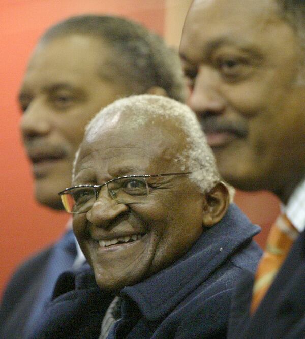 (From left) Bernard C. Parks, Archbishop Desmond Tutu and Jesse Jackson smile during an induction ceremony at the King Historic Center.  (John Spink/AJC File).