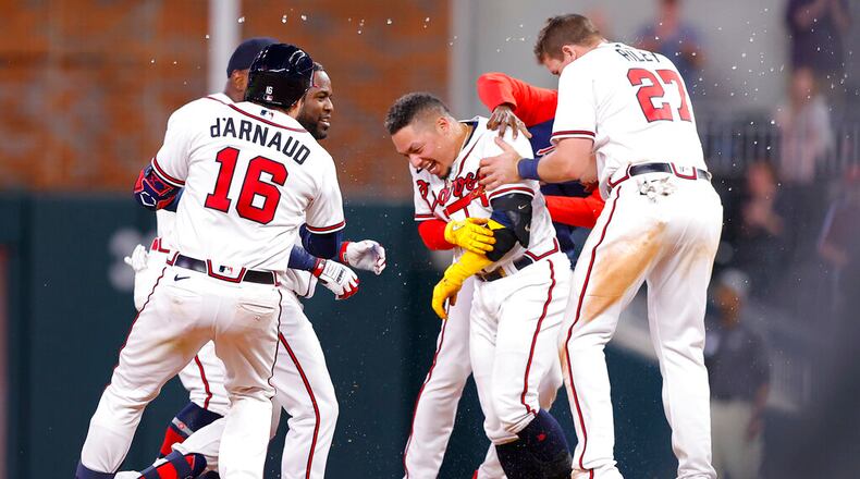 Atlanta's William Contreras reacts with teammates after his game-winning single in the ninth inning against the Phillies on Tuesday night at Truist Park. (AP Photo/Todd Kirkland)