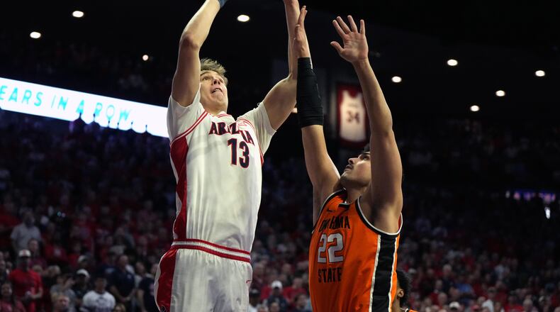 Arizona center Motiejus Krivas (13) shoots over Oklahoma State center Parsa Fallah during the first half of an NCAA college basketball game, Saturday, Feb. 7, 2026, in Tucson, Ariz. (AP Photo/Rick Scuteri)