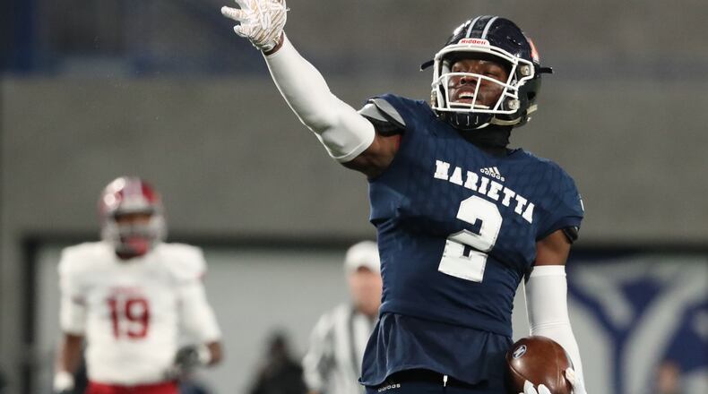 Marietta tight end Arik Gilbert (2) celebrates a first down catch in the first half against Lowndes during the Class AAAAAAA high school football state title game at Georgia State Stadium Saturday, December 14, 2019 in Atlanta. (JASON GETZ/SPECIAL TO THE AJC)