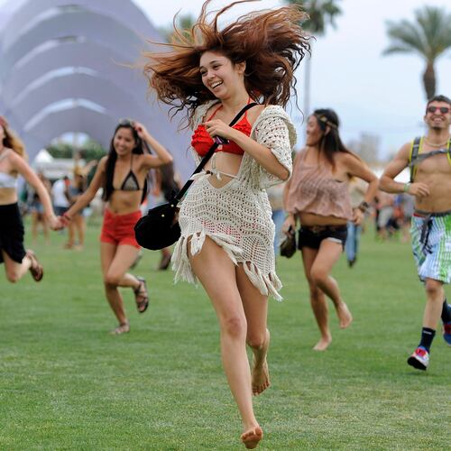 FILE - Festivalgoers run toward the main stage at the Coachella Valley Music and Arts Festival in Indio, Calif., on April 13, 2012. (AP Photo/Chris Pizzello, File)