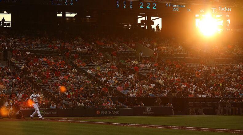080315 ATLANTA: The setting sun breaks through a tunnel at Turner Field as Braves Freddie Freeman bats during early innings against the Giants in a baseball game on Monday, August 3, 2015, in Atlanta. Freeman ending up leaving the game shortly after his at bat. Curtis Compton / ccompton@ajc.com