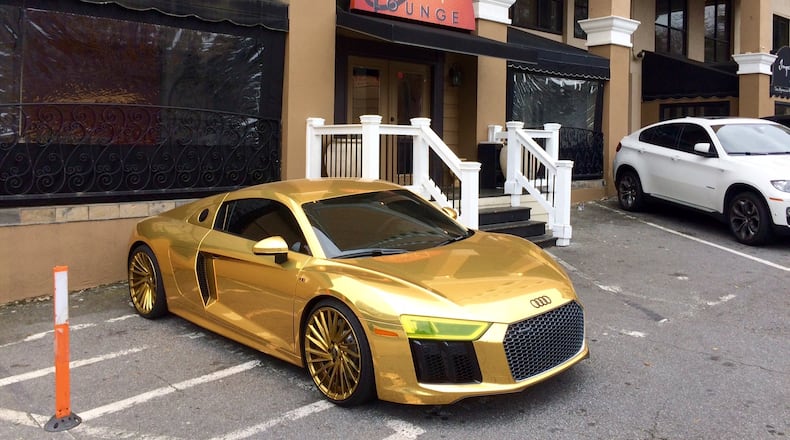 The golden Audi R8 (list price starts at $163,000) belonging to Atlanta Hawks star Dennis Schroder is often spotted outside his nightclub in Buckhead. (Photo by Bill Torpy)