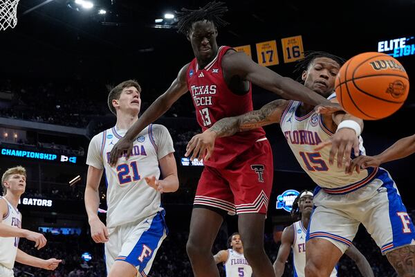 Texas Tech forward Federiko Federiko (33) and Florida guard Alijah Martin (15) battle for the loose ball during the second half in the Elite Eight of the NCAA college basketball tournament, Saturday, March 29, 2025, in San Francisco. (AP Photo/Godofredo A. Vásquez)